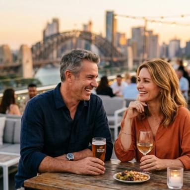 Hooking up after 40 in Australia Confident Australian couple in their late 40s sharing a relaxed evening at a stylish Sydney rooftop bar at golden hour